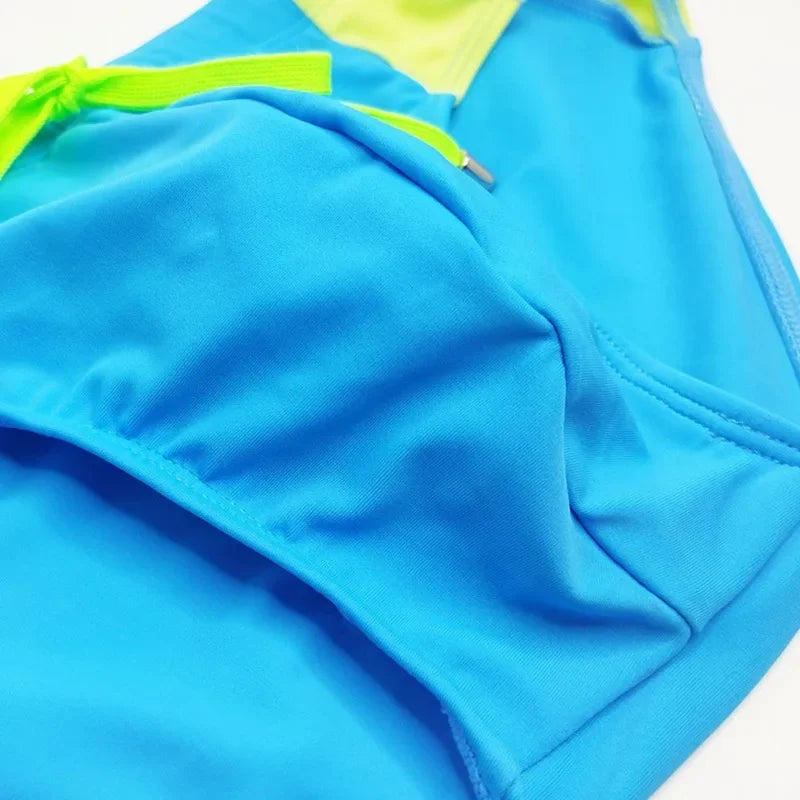 2025Men's side color matching triangle swimming trunks tethered close-fitting fashion trendy men's beach briefs men's UXH332